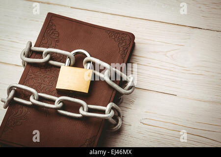 Open bible chained with lock