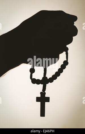 Hand holding rosary beads Stock Photo