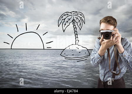 Composite image of geeky hipster holding a retro camera Stock Photo