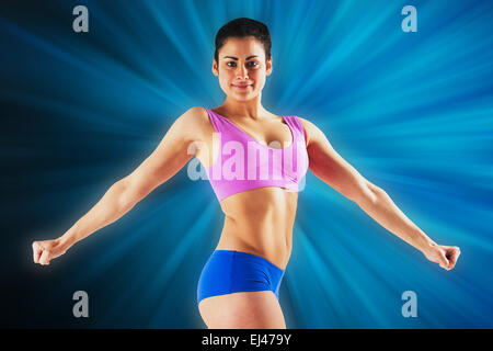 Composite image of fit brunette posing and looking at camera Stock Photo