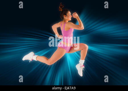 Composite image of fit brunette running and jumping Stock Photo
