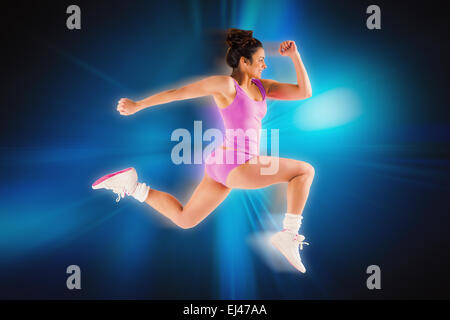Composite image of fit brunette running and jumping Stock Photo