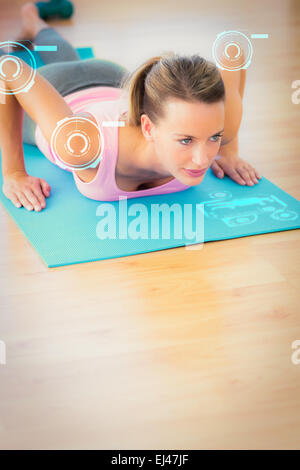 Composite image of determined beautiful woman doing push ups Stock Photo