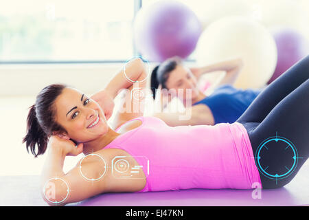 Composite image of two fit young women doing pilate exercises Stock Photo