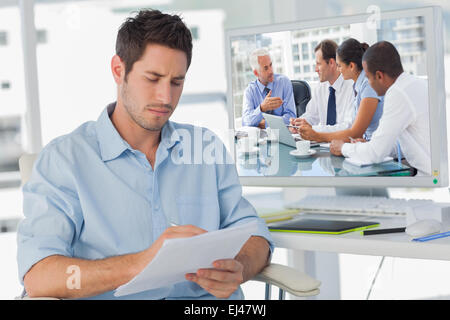 Composite image of group of business people brainstorming together Stock Photo