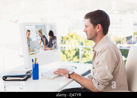 Composite image of casual business people around conference table in office Stock Photo