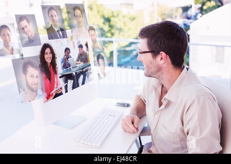 Composite image of smiling designer using tablet Stock Photo
