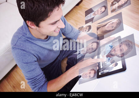 Composite image of overhead view of man using digital tablet in living room Stock Photo