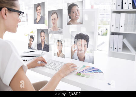 Composite image of female photo editor working on computer Stock Photo