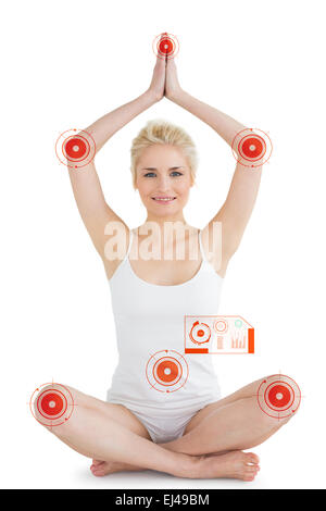 Composite image of toned young woman sitting with joined hands over head Stock Photo