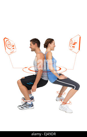 Composite image of side view of a fit young couple doing squats Stock Photo