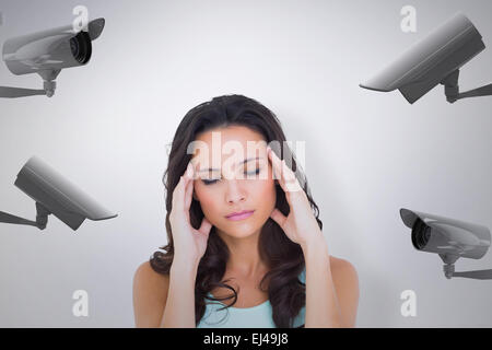 Composite image of pretty brunette with a headache Stock Photo