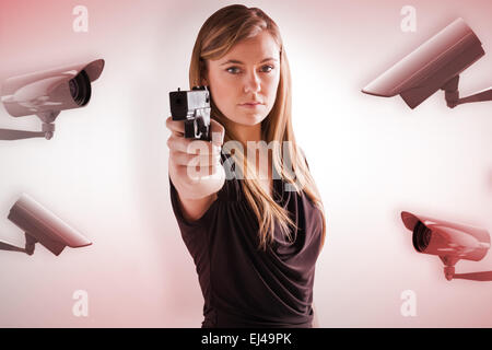Composite image of femme fatale pointing gun at camera Stock Photo