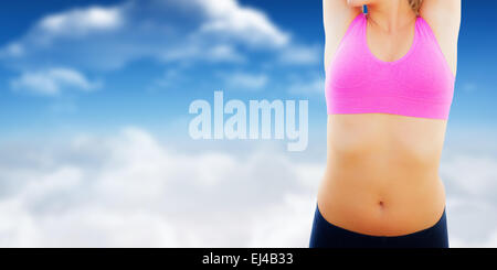 Composite image of smiling toned woman stretching hands on beach Stock Photo
