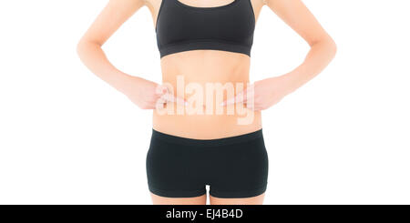 Closeup mid section of a fit woman with hands on stomach Stock Photo