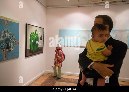 Visitor watches contemporary visual art exhibition during 2nd Grand Festival of Art for Peace in Tehran, Iran Stock Photo