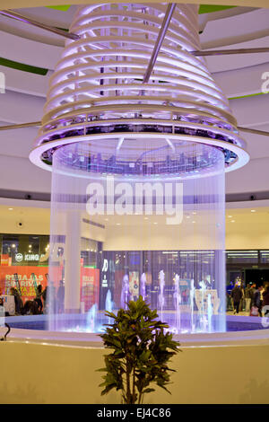 SPAIN - JANUARY 21, 2015: People shopping around the ceiling fountain with lights in the mall El Faro on January 21, 2015 in Bad Stock Photo