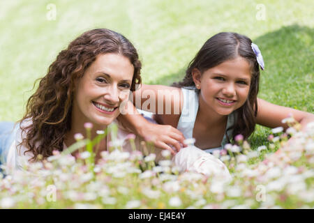 Happy mother and daughter lying on the grass Stock Photo