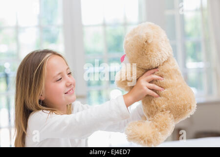 Happy little girl holding her teddy Stock Photo