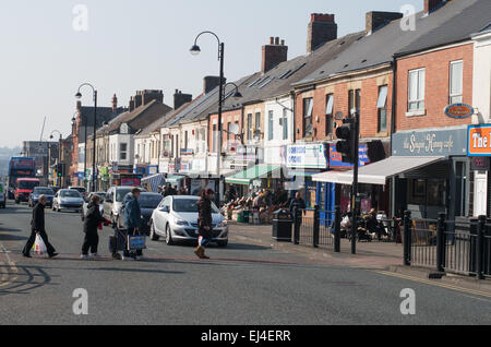 People crossing Shields Road, Byker high street, north east England, UK Stock Photo