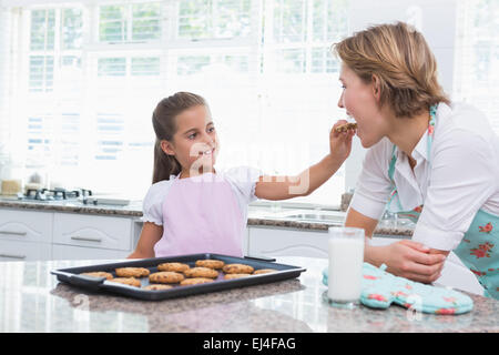 Mother and daughter with hot fresh cookies Stock Photo