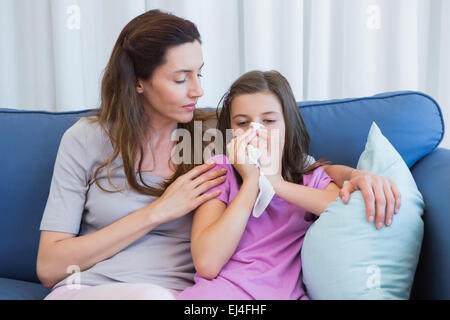 Mother helping daughter blow her nose Stock Photo - Alamy