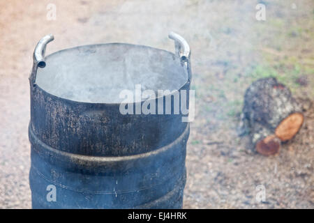 Traditional home slaughtering in a rural area. Smoking scalding pot Stock Photo