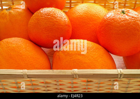 Oranges and tangerines in basket Stock Photo