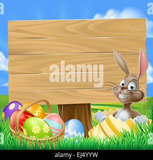 Easter Bunny Egg Hunt Sign with a cartoon Easter bunny and a basket of decorated chocolate Easter eggs Stock Photo