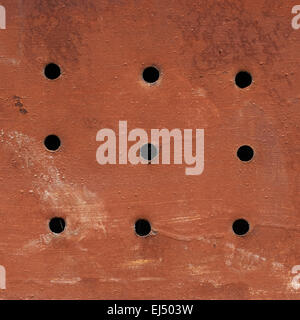 Painted grungy metal surface with holes Stock Photo