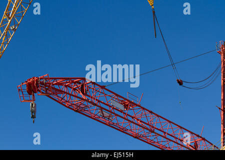 Liverpool city centre construction site. Huge crane being dismantled with an even bigger 750 ton level-luffing; Luffer Crane with hydraulic luffing jibs, (machinery used in tight urban development work spaces when there is insufficient building clearance, tall buildings or congested sites for the lifting jib mechanism to rotate), one of the biggest cranes of its type in Europe and one of only three in the UK. Stock Photo