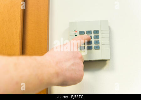 Man introduces code on access panel Stock Photo