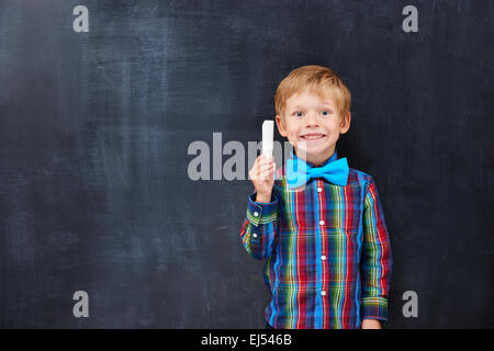 Boy with red hair looking forward far classwork Stock Photo