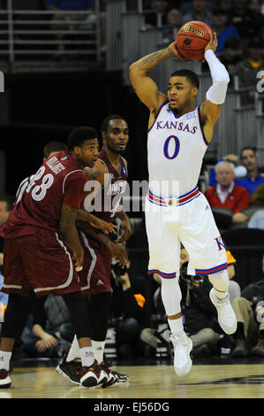 March 20, 2015: Kansas Jayhawks guard Frank Mason III (0) is in the air looking where to pass as the Aggie defense looks on during the NCAA Men's Basketball Tournament Midwest Regional game between the New Mexico State Aggies and the Kansas Jayhawks at the Centurylink Center in Omaha, Nebraska. Kansas won the game 75-56. Kendall Shaw/CSM Stock Photo