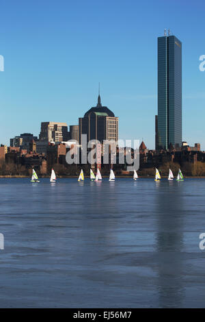 Boston Skyline, sail boats and Prudential Bld. in winter on half frozen Charles River, Massachusetts, USA Stock Photo