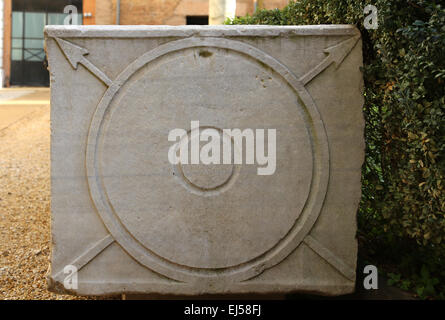 Roman sarcophagus. Lateral side. Relief of a shield and spear. Courtyard. Baths of Diocletian. Rome. Italy. Stock Photo