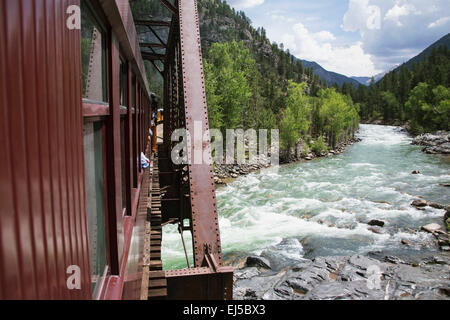 The Durango and Silverton Narrow Gauge Railroad Steam Engine travels along Animas River, Colorado, USA Stock Photo