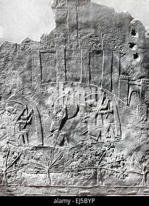This marble slab was uncovered during excavations of the Southwest Palace at the ancient city of Nineveh, on the eastern bank of the Tigris River. The figures show an Assyrian assault  between 700 to 692 B.C. on the city of Alammu (thought to be present-day Jerusalem) by the Assyrians under Sennacherib. Note that the besieging archers are protected by wicker screens. This slab is now housed in the British Museum Stock Photo