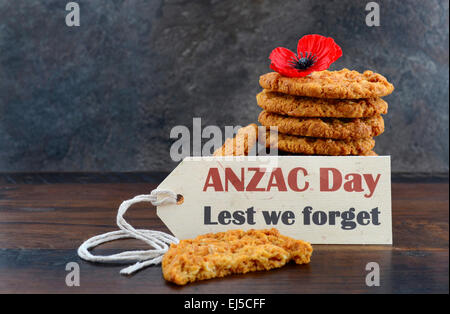 Australian Anzac biscuits with Anzac DAy, Lest We Forget message on dark wood and slate background. Stock Photo
