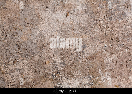An old and worn painted concrete floor.  Because of its age the paint is now cracked and peeling. Stock Photo