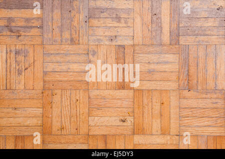 A detail photo showing parquet wood flooring that has been worn over time. Stock Photo