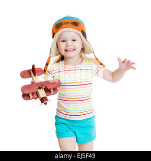 happy child pilot and playing with wooden airplane toy Stock Photo