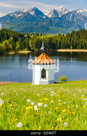 Landscape in Bavaria with chapel, lake and alps mountains Stock Photo