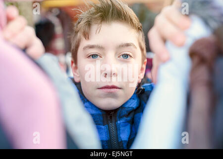 portrait of a teenage boy who is looking after clothes on a flea market Stock Photo