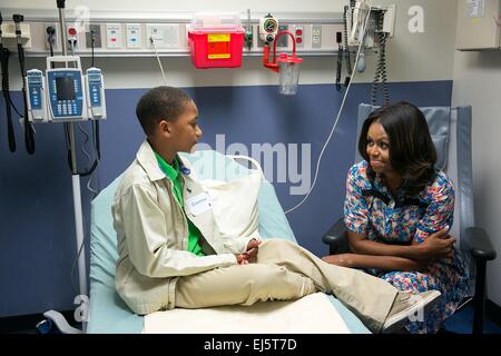First Lady Michelle Obama visits with young patient Camron Stevens in his room at St. Jude Children's Research Hospital September 17, 2014 in Memphis, Tennessee. Stock Photo
