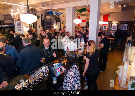 Bar and barmaid / staff / barman man & rugby fan fans at busy The Bear pub / public house. Twickenham UK; popular on match days. Stock Photo