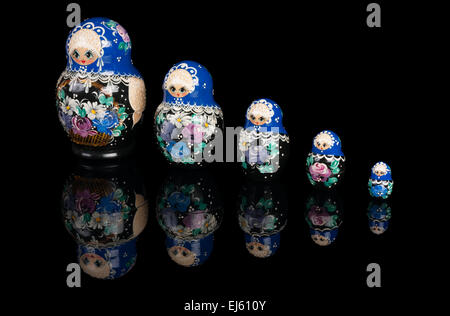 Matryoshka is a set of Russian wooden dolls of decreasing size placed one inside the other. Isolated on white Stock Photo
