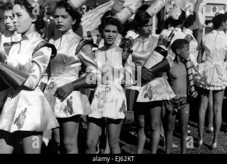 AJAXNETPHOTO . 1956. ST.GEORGES, GRENADA, WEST INDIES. - YOUNG GIRLS WEARING GRANTS SCOTCH WHISKEY SPONSORED DRESS AWAITING THE PARADE BEFORE JUDGES. PHOTO; REG CALVERT/AJAX  ©AJAX NEWS & FEATURE SERVICE/REG CALVERT COLLECTION   REF: 1957 BW007 Stock Photo