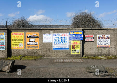 Signs outside a MOT Testing Centre offering welding services, tyres, repairs and scrappage. Stock Photo