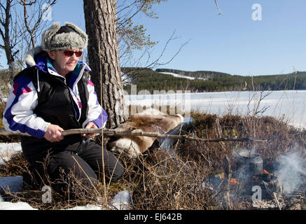 Older women from the North of Sweden making coffee over a campfire Stock Photo